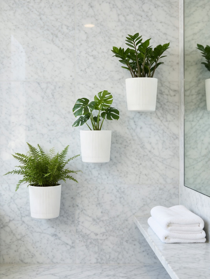 White round fluted wall planters with greenery in a marble bathroom