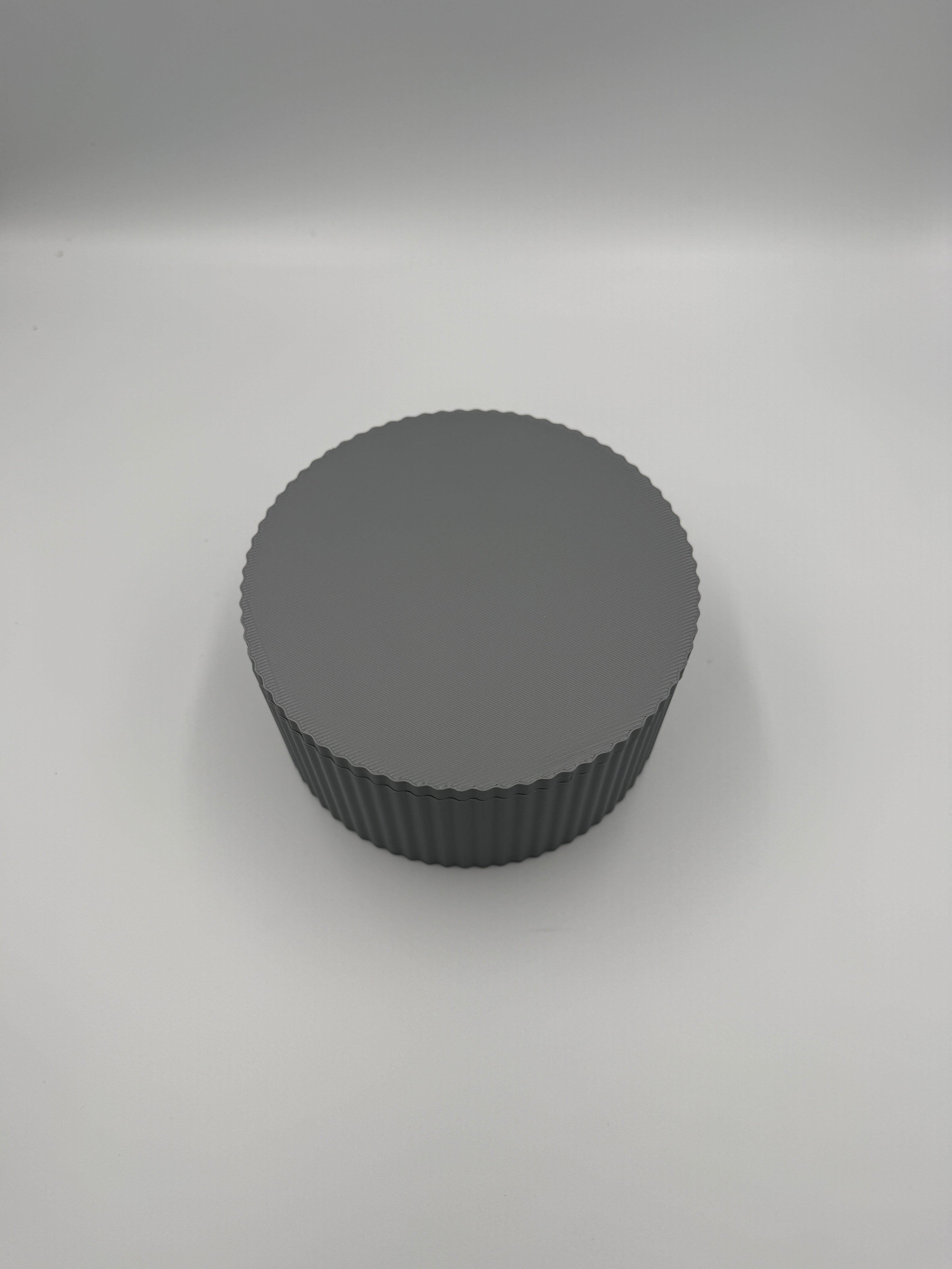 Grey fluted cylinder storage box with elegant vertical ribbed texture