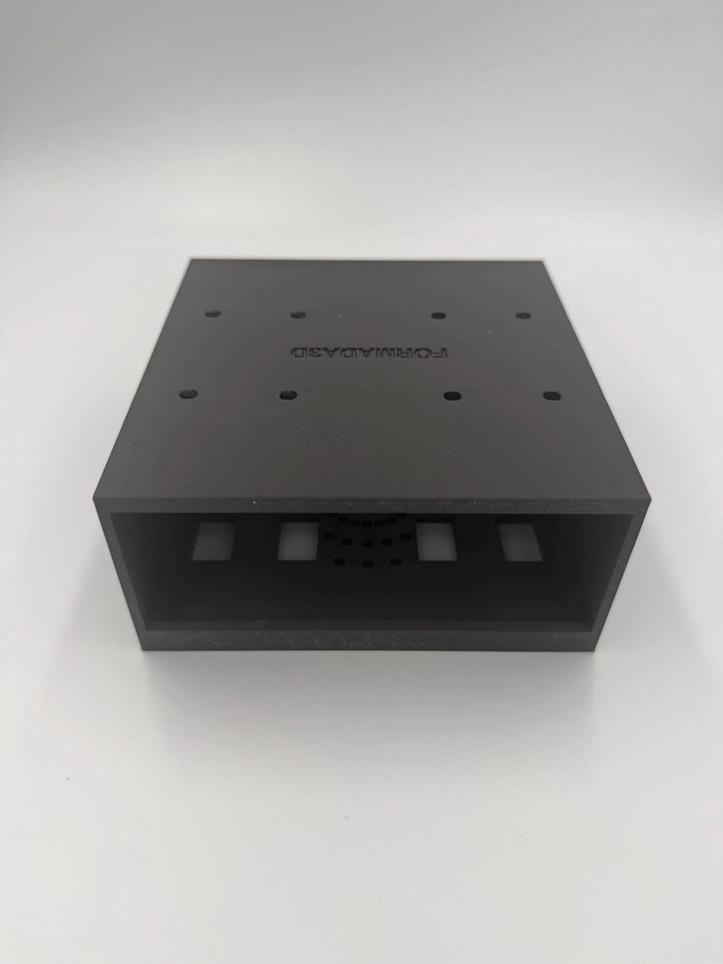 Detail view of the Mac Mini M4 under-desk mount showing ventilation and mounting holes