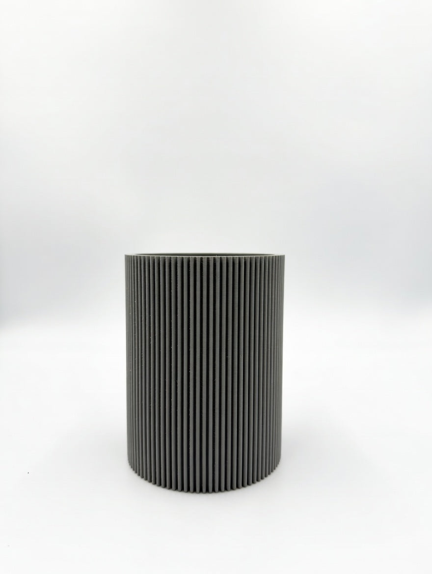 Round fluted pencil holder holding pens and pencils