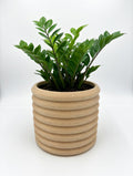 Knit Stack 3D printed planter styled with a houseplant on a shelf