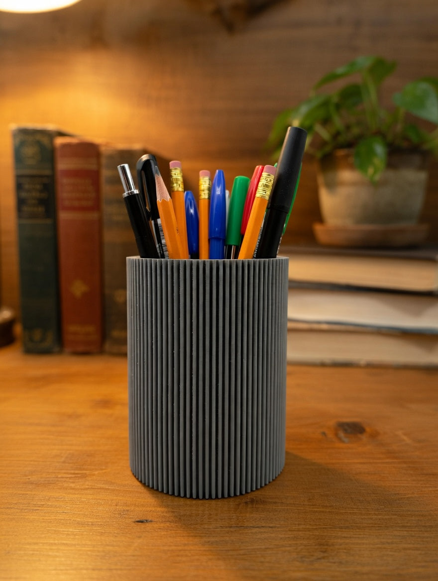 Round fluted pencil holder used as a makeup brush holder