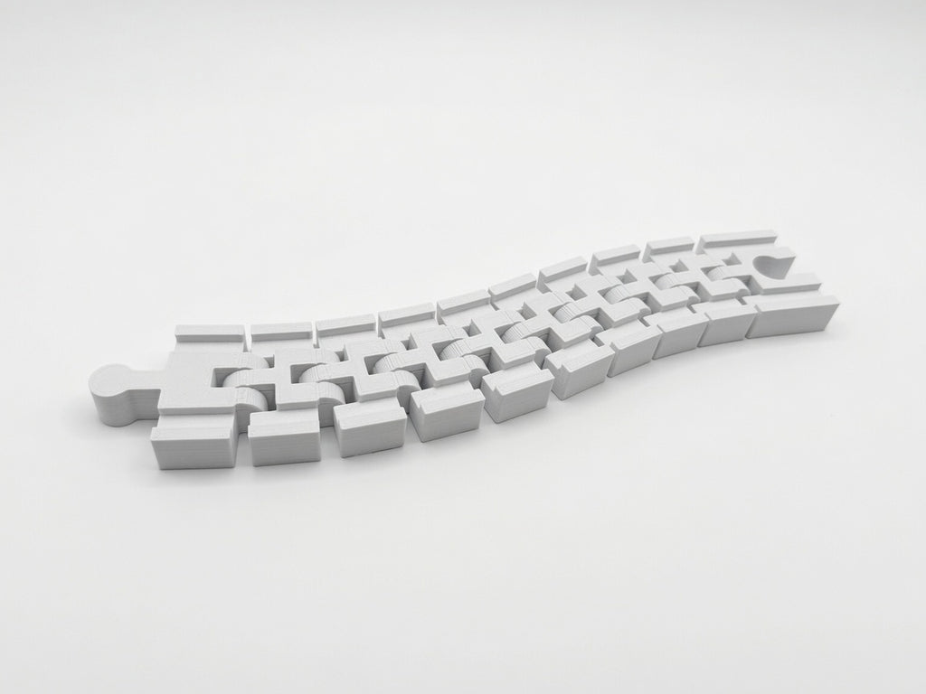 Flexible track segments articulating on their built-in hinges