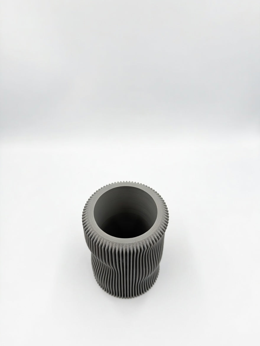 Soft organic fluted pencil holder with wavy sculptural silhouette on a desk