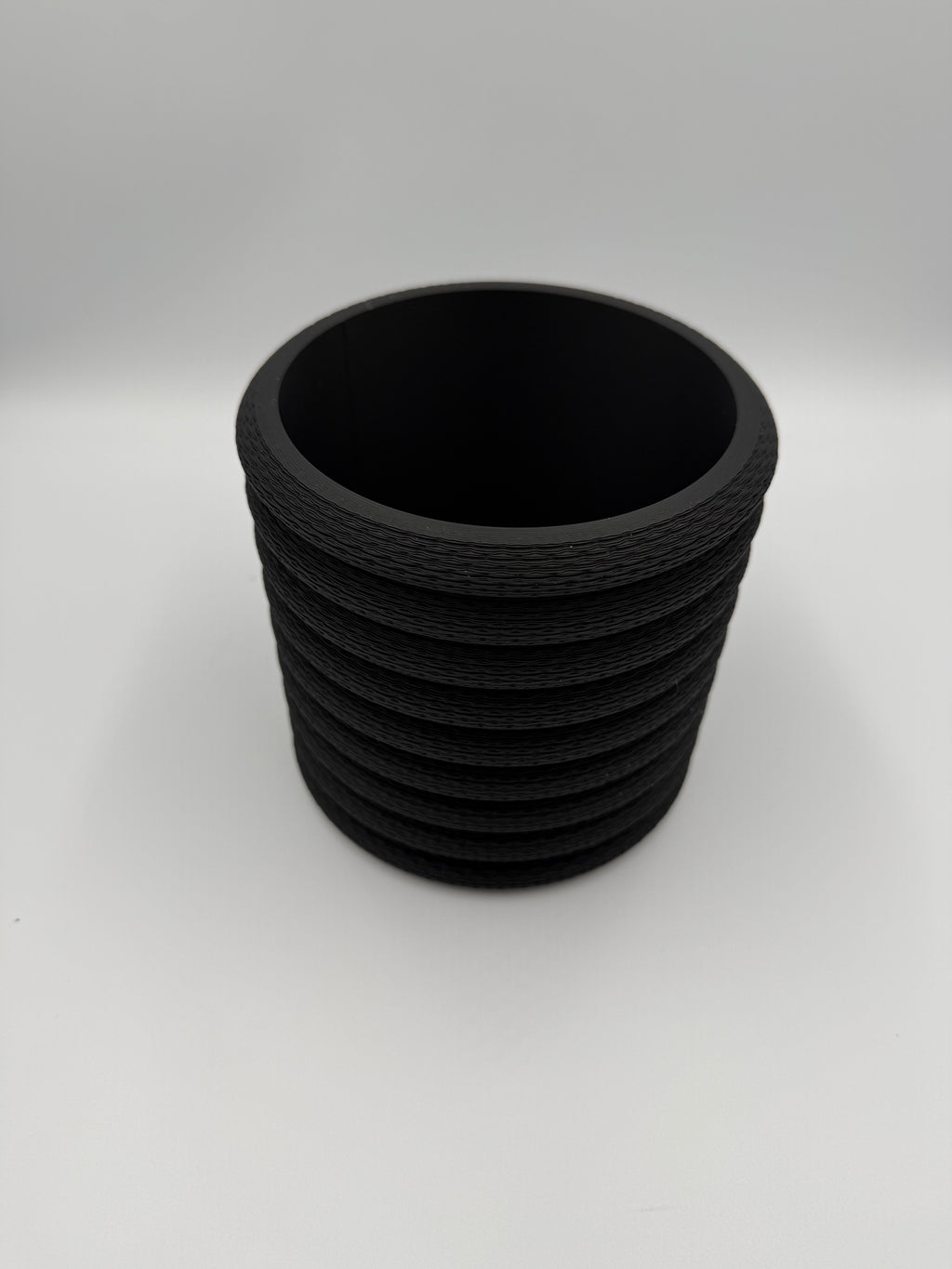 Black Knit Stack wall planter, angled three-quarter view showing knit texture