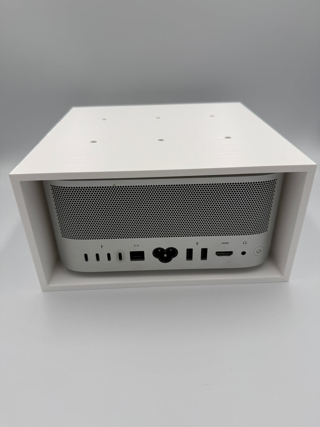 Front retaining lip and screw holes that keep the Mac Studio securely in place