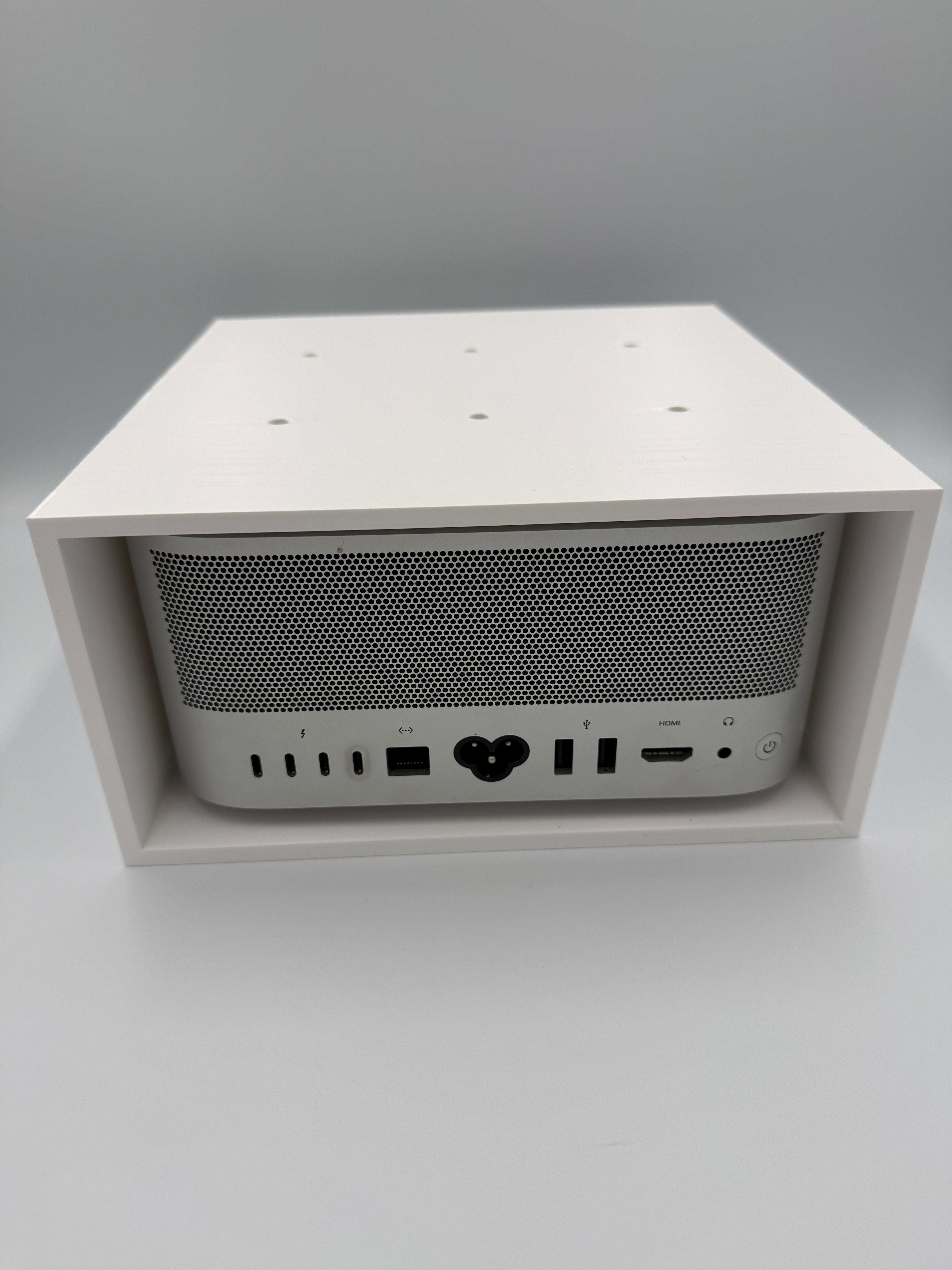 Front retaining lip and screw holes that keep the Mac Studio securely in place