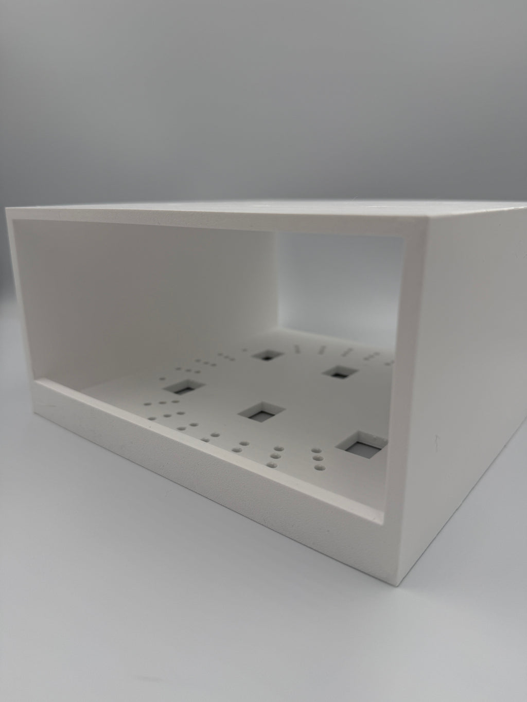 Interior view showing screwdriver access slots for installation from below