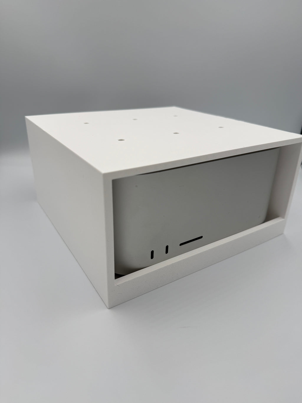Mac Studio under-desk mount cage shown at an angle with Mac Studio installed