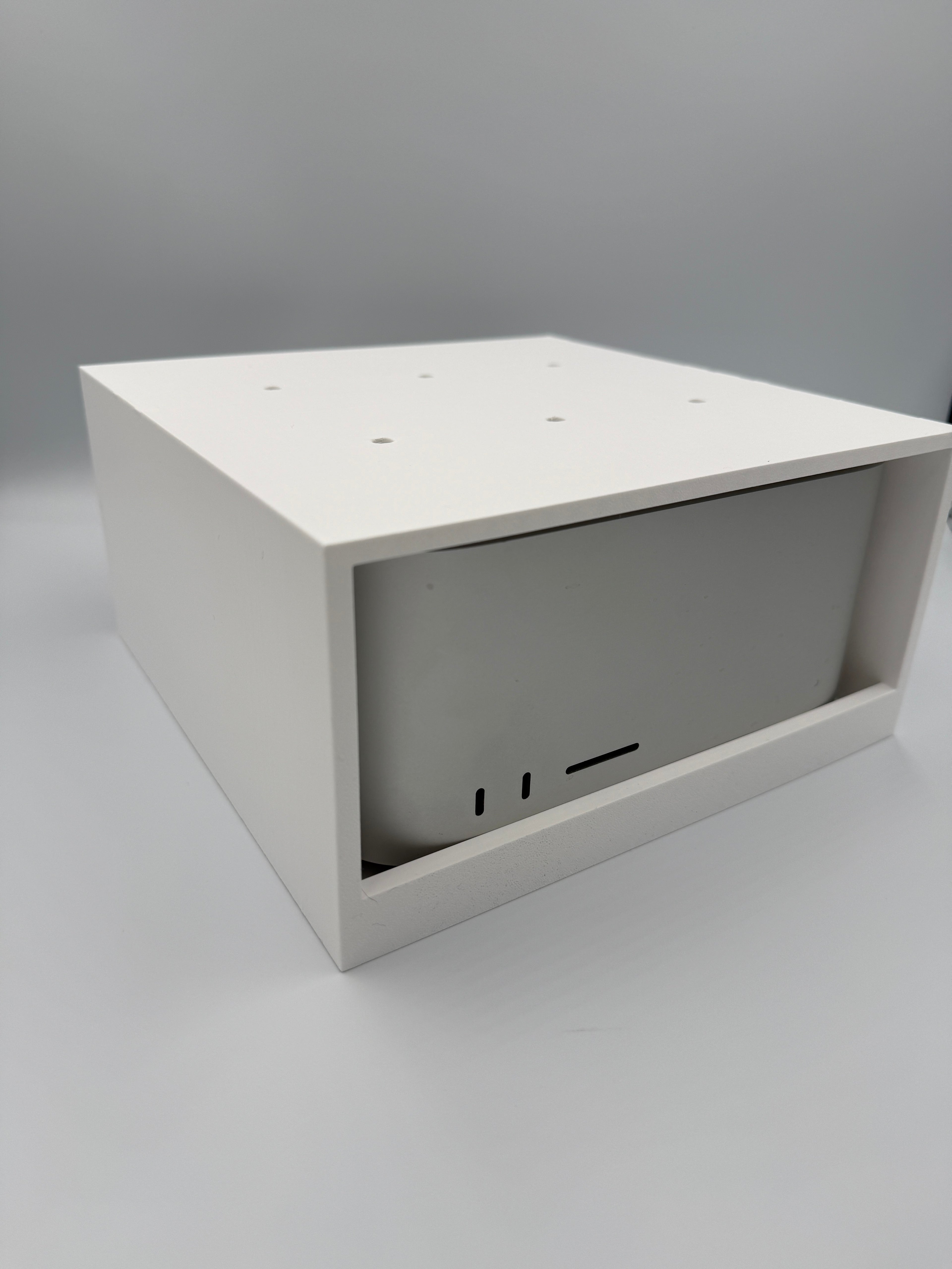 Mac Studio under-desk mount cage shown at an angle with Mac Studio installed