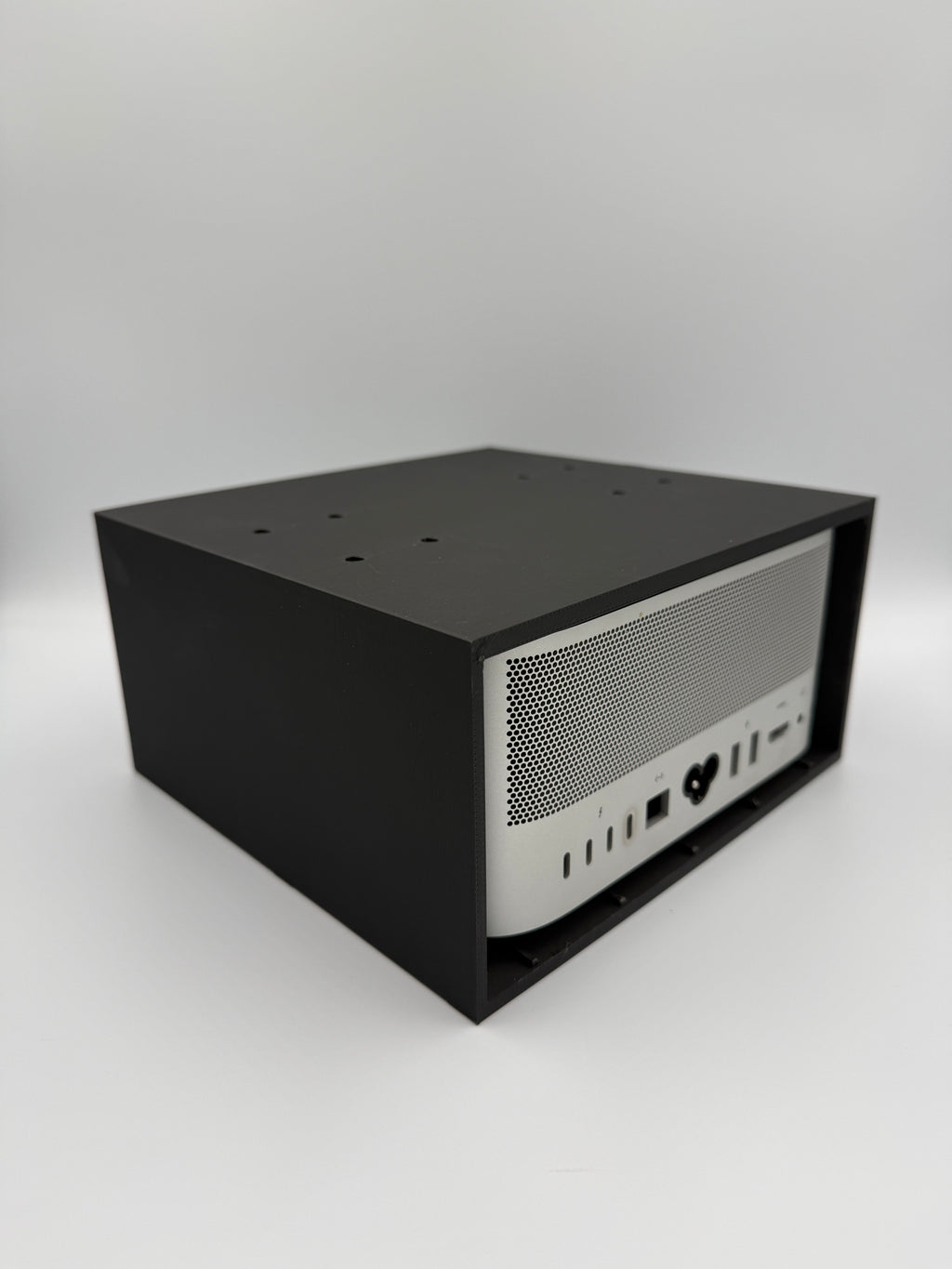 Installed cage mount viewed from the rear with full access to Mac Studio ports