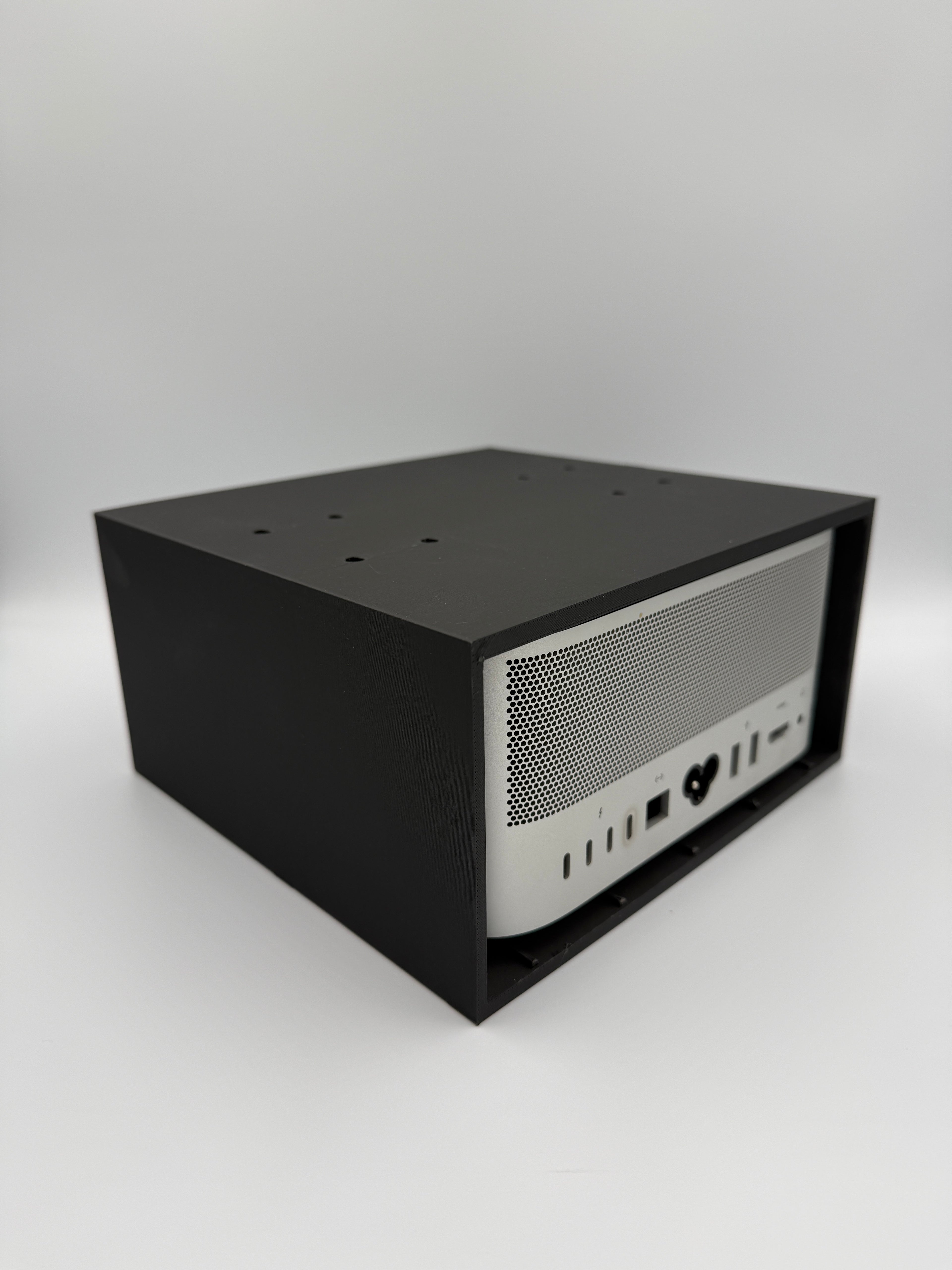 Installed cage mount viewed from the rear with full access to Mac Studio ports