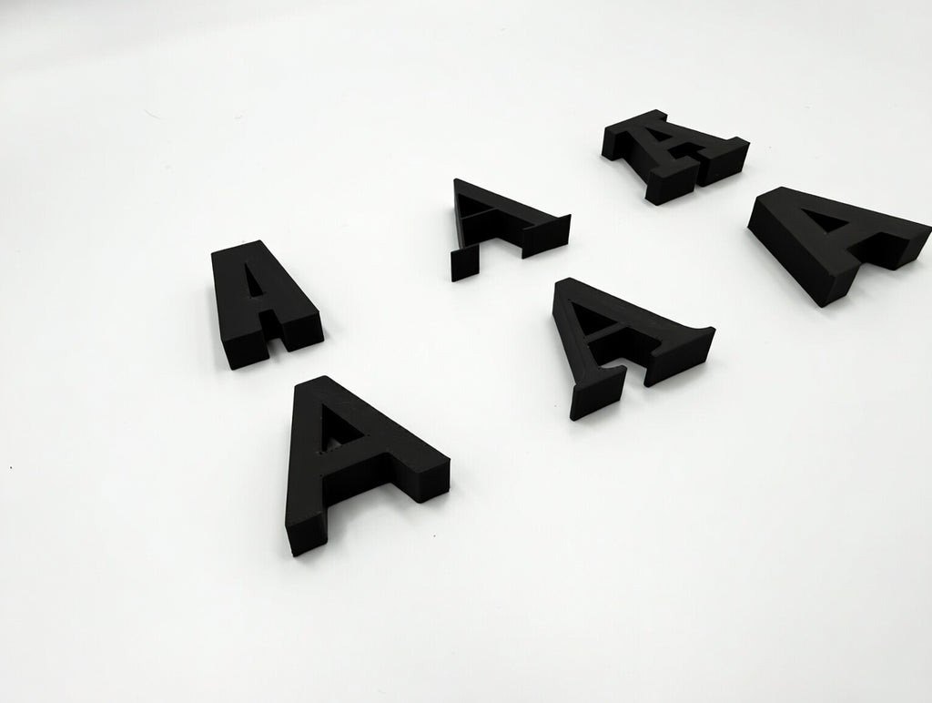 Black letter A in six different fonts, angled perspective