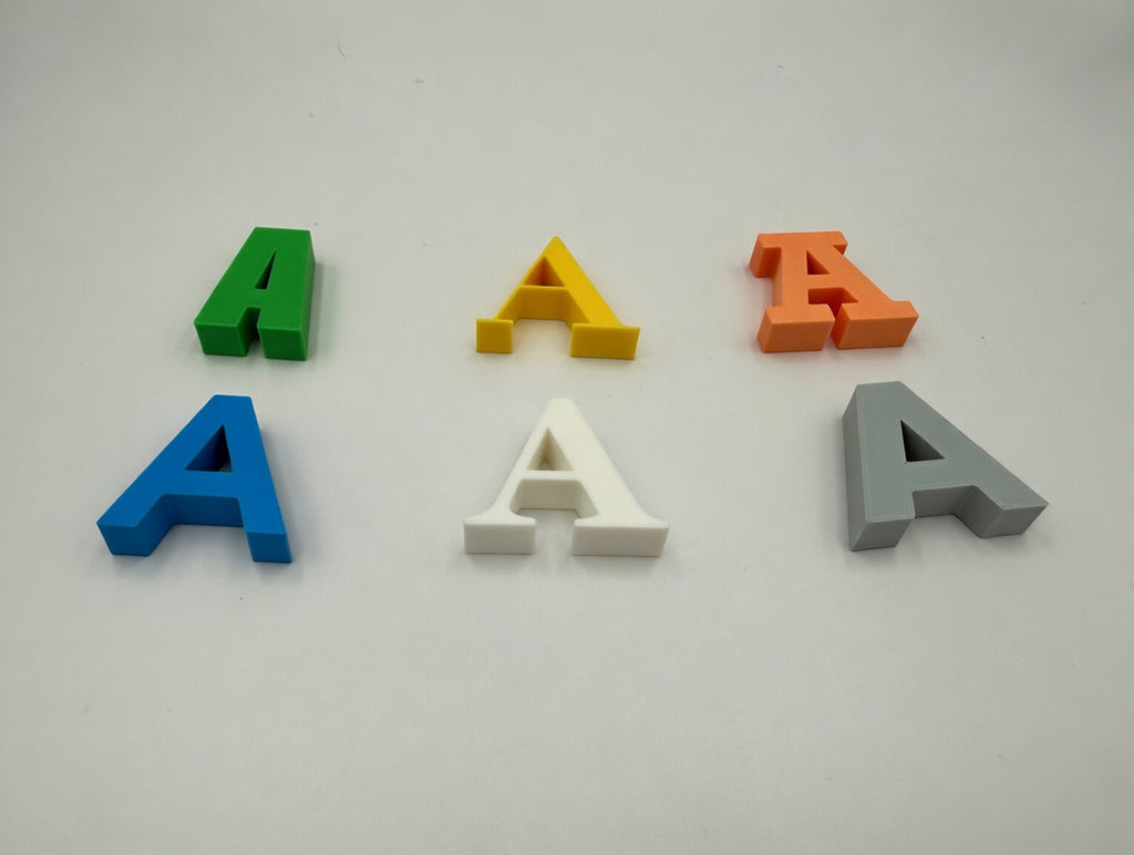 Letter A printed in six fonts and multiple colour variants, flat lay