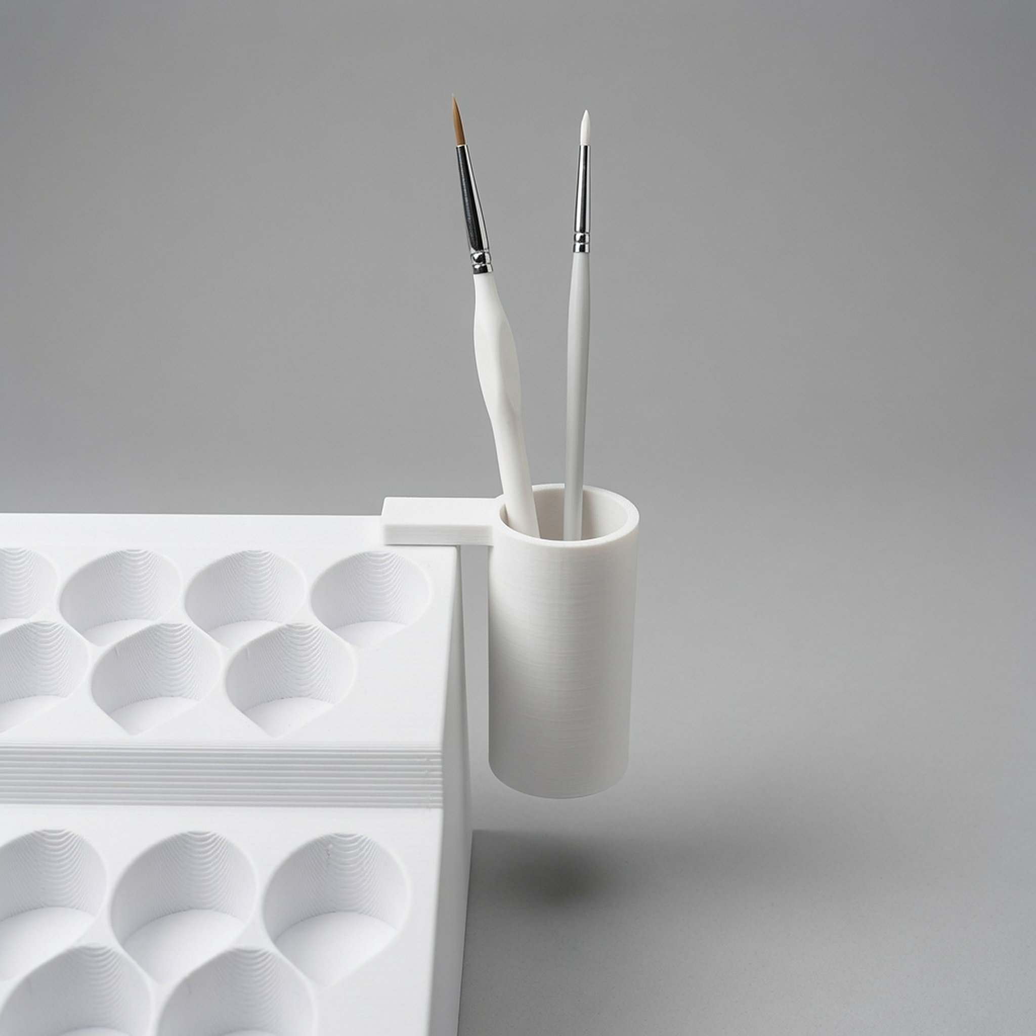 Clip-on brush holder mounted on a Formada3D paint rack, holding brushes