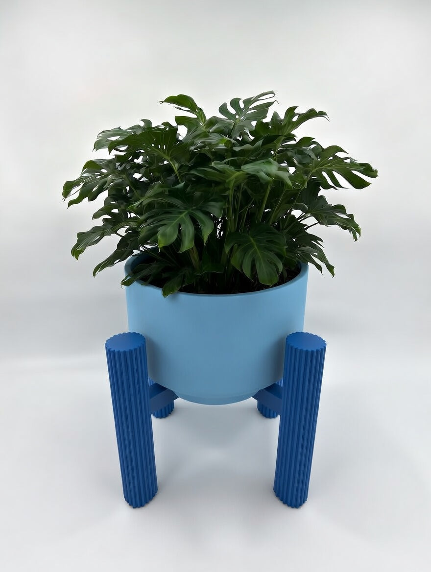 Blue round fluted elevated plant stand with monstera, front view