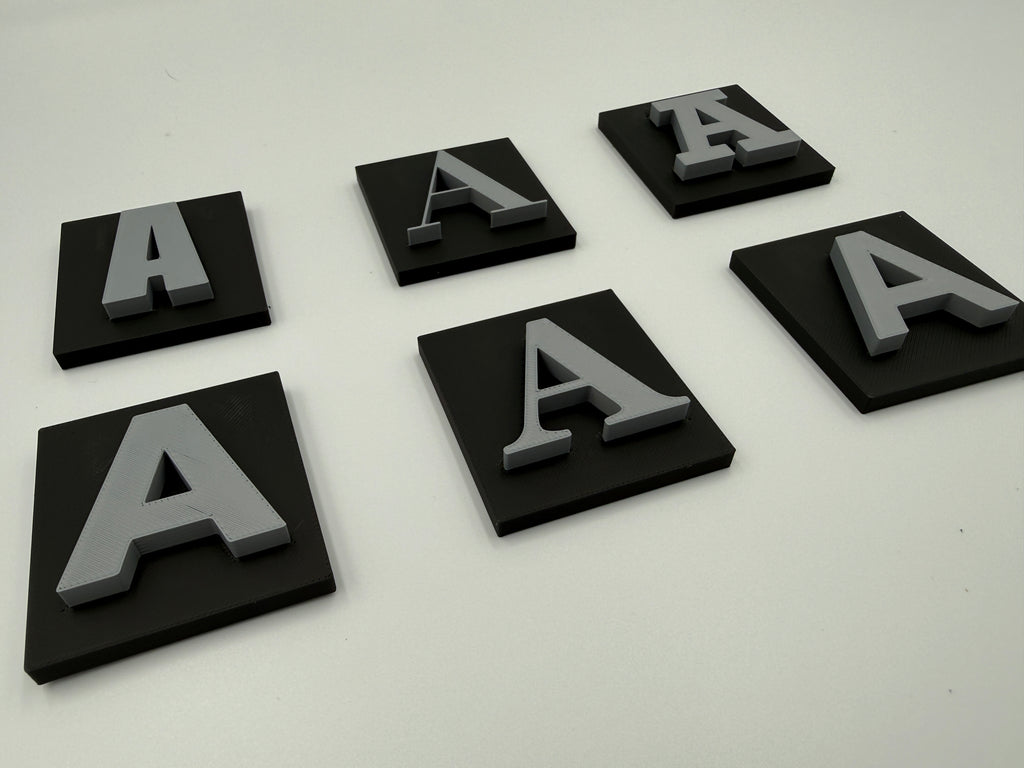 Angled view of two-colour shadow letters with base plates