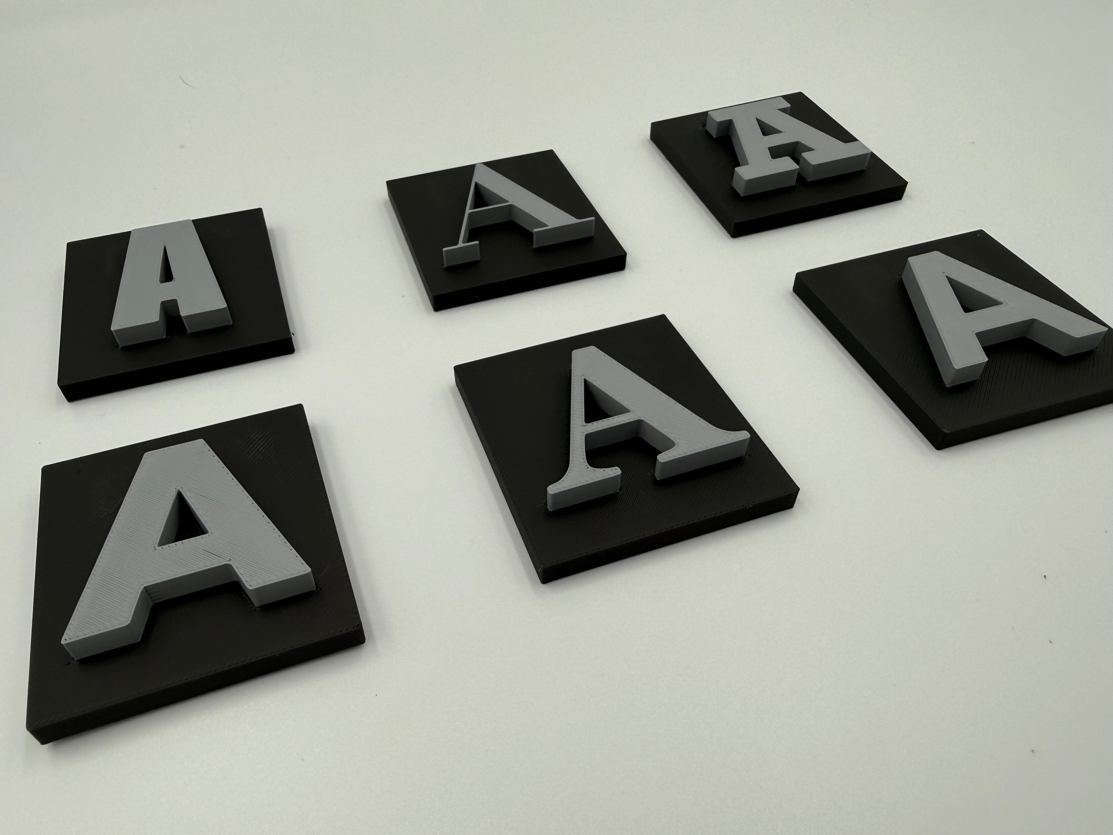 Angled view of two-colour shadow letters with base plates