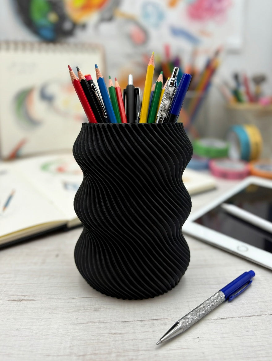 Black wavy twisted pencil holder in a creative art studio workspace